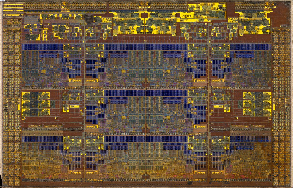 Intel processor silicon die-shot under microscope showing advanced packaging and interconnect layers