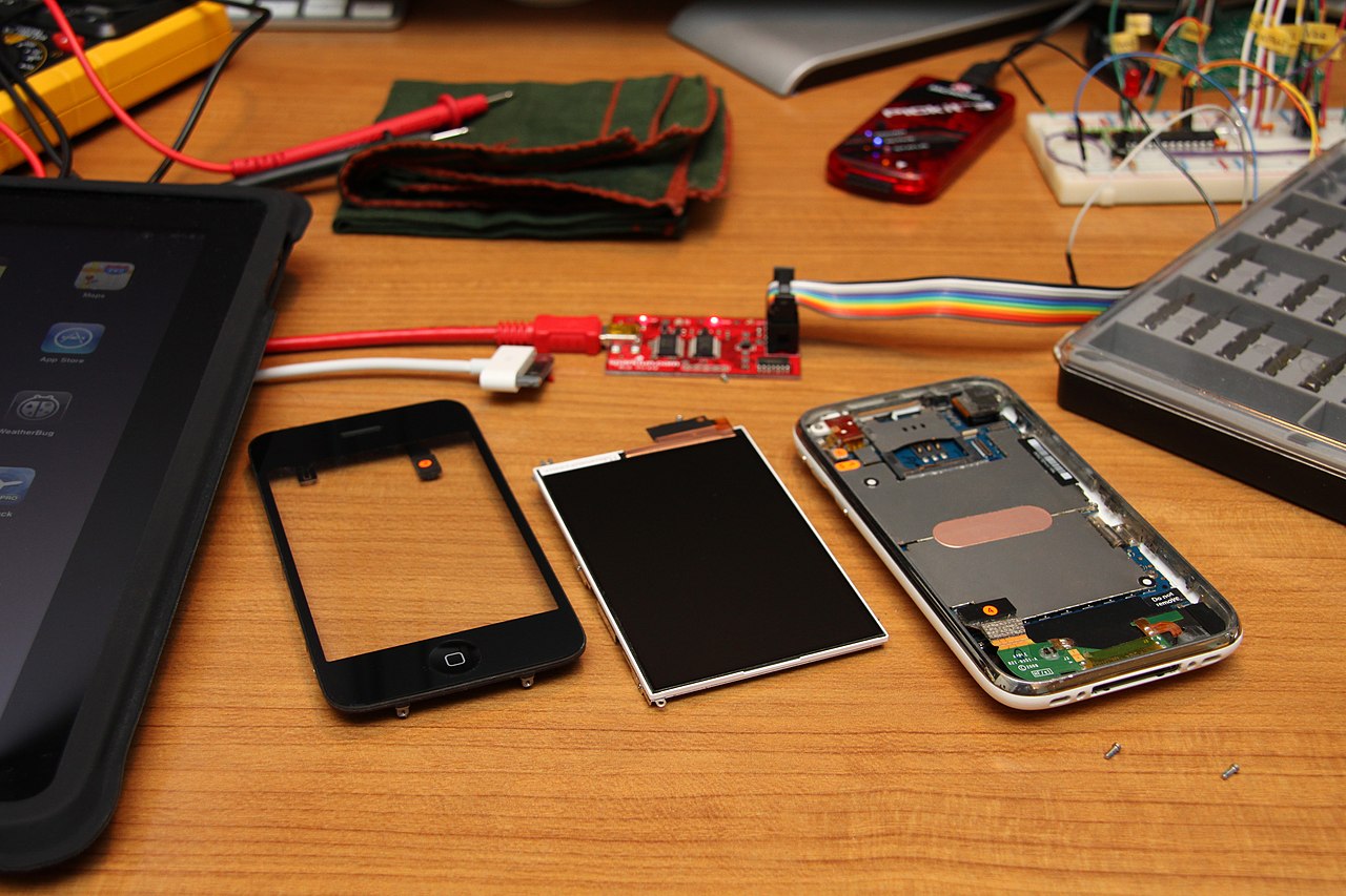 Disassembled iPhone showing internal memory and logic components affected by rising DRAM costs