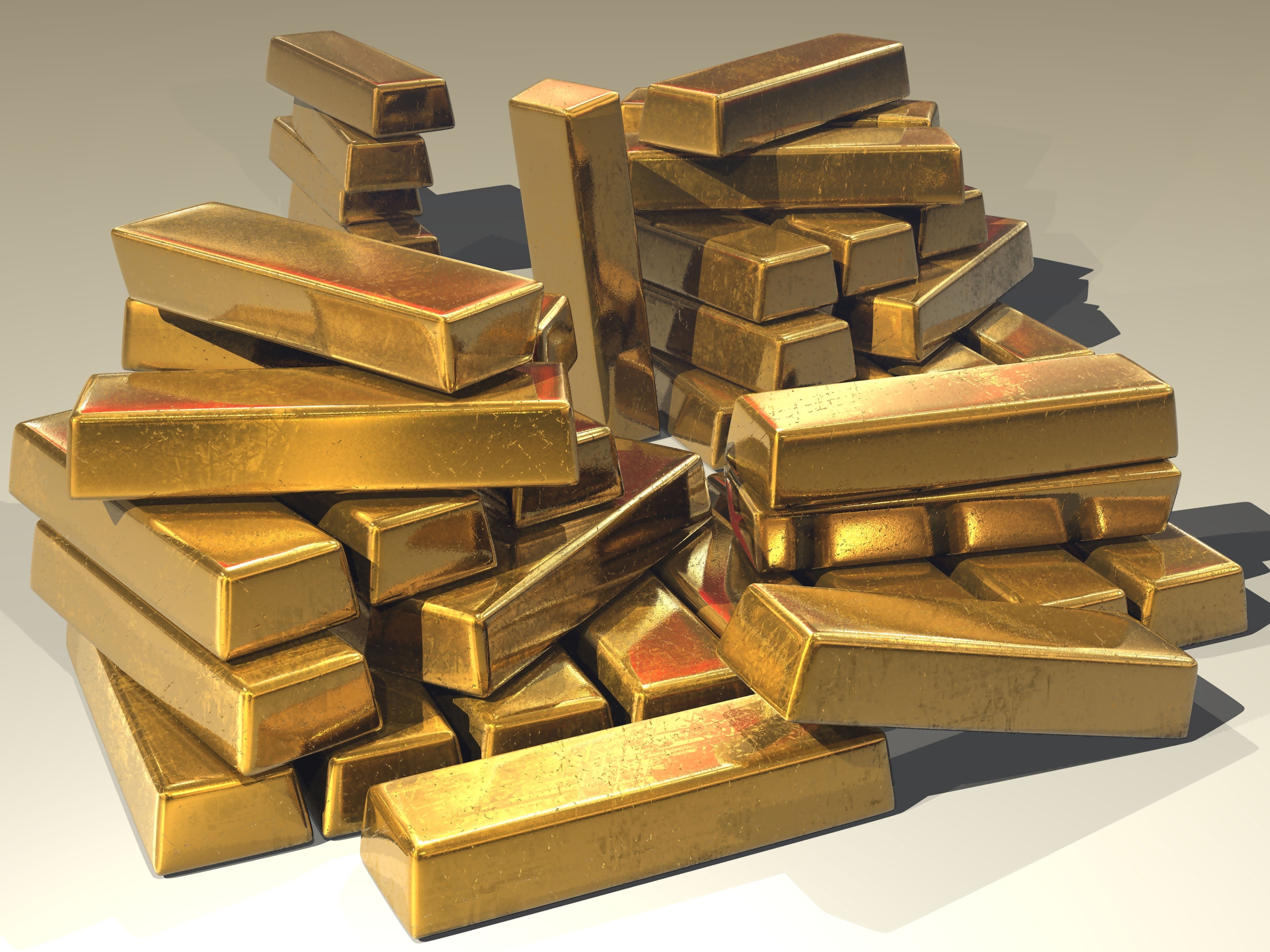 Stacked gold bullion bars, the classic safe-haven asset used to hedge portfolios against geopolitical risk